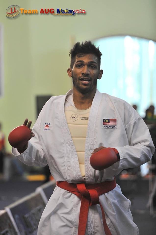 Theebaan G in competition gi and red mitts at a national karate meet